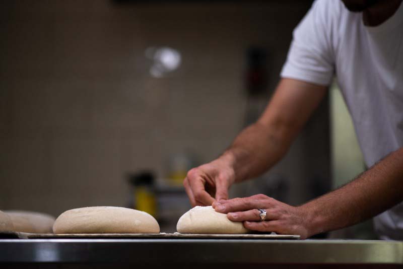 Hand making fresh bread
