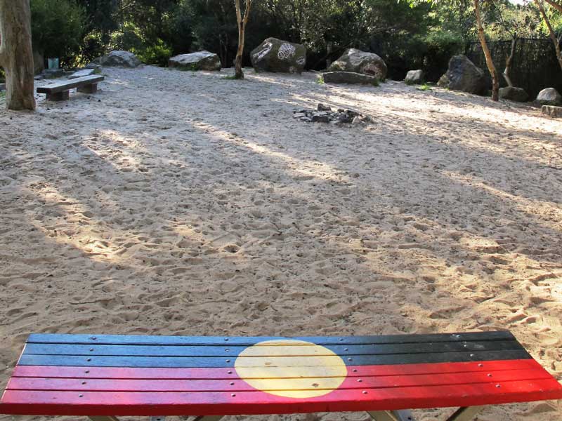 Indigenous flag, seat, dappled sunlight
