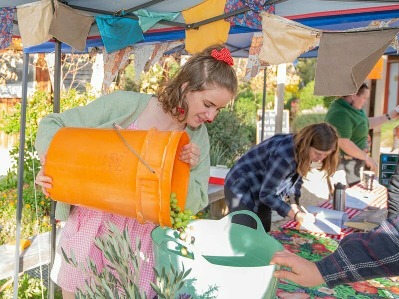 Community Festival, person emptying orange bucket